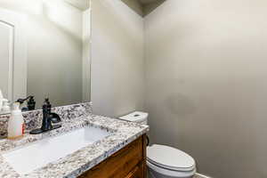 Half bath featuring vanity and toilet