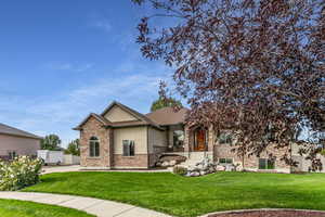 View of front of house featuring stucco siding and stone siding