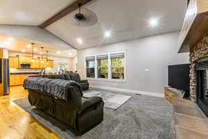 Living area featuring a stone fireplace, light wood finished floors, and recessed lighting