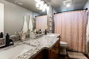 Bathroom featuring a textured ceiling and vanity
