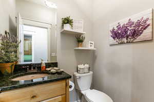 Half bath featuring vanity and toilet