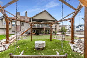 Rear view of property with a patio, a chimney, stairs, and stucco siding