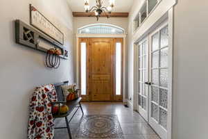 Entryway featuring healthy amount of natural light, a chandelier, and french doors