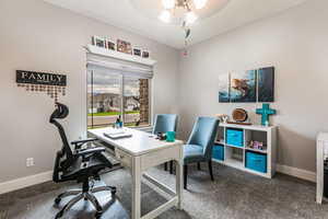 Office area featuring carpet flooring and a ceiling fan