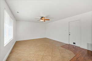 Spare room with light tile patterned flooring and ceiling fan