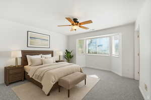 Carpeted bedroom with baseboards and a ceiling fan