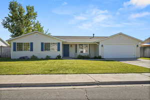 Ranch-style home with covered porch, concrete driveway, a garage, and roof with shingles