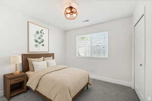 Bedroom with carpet floors and a closet