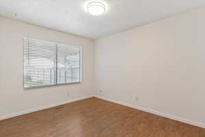 Spare room with light wood-style floors and a textured ceiling