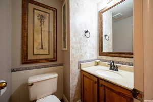 Bathroom featuring vanity and tile walls