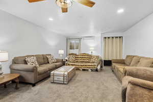 Living room with light carpet, ceiling fan, and recessed lighting