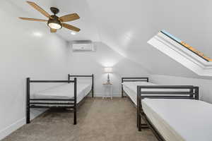 Bedroom with vaulted ceiling, light colored carpet, ceiling fan, a skylight, and recessed lighting