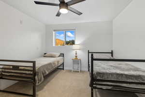 Bedroom with light carpet and a ceiling fan