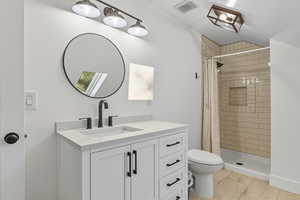 Full bathroom featuring vanity and a shower stall