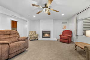 Living area with carpet, a fireplace, recessed lighting, and ceiling fan