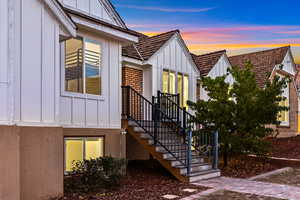Property entrance featuring board and batten siding