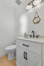 Bathroom featuring vanity and light wood-style floors