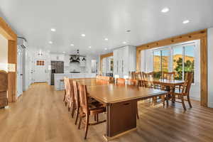 Dining space with recessed lighting, light wood-style floors, and a wall unit AC
