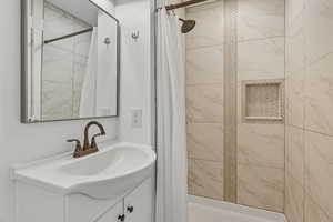 Full bath with vanity and a stall shower
