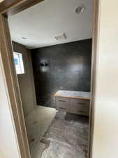 Bathroom featuring tile walls