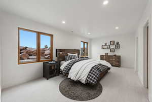 Bedroom with recessed lighting and light colored carpet