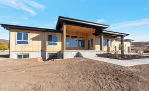 Rear view of property featuring covered porch and a mountain view