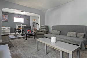 Living area with arched walkways and baseboards