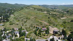 Aerial view of property and surrounding area featuring mountains
