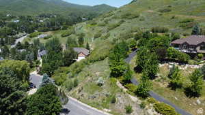 Aerial view of property's location with a mountainous background