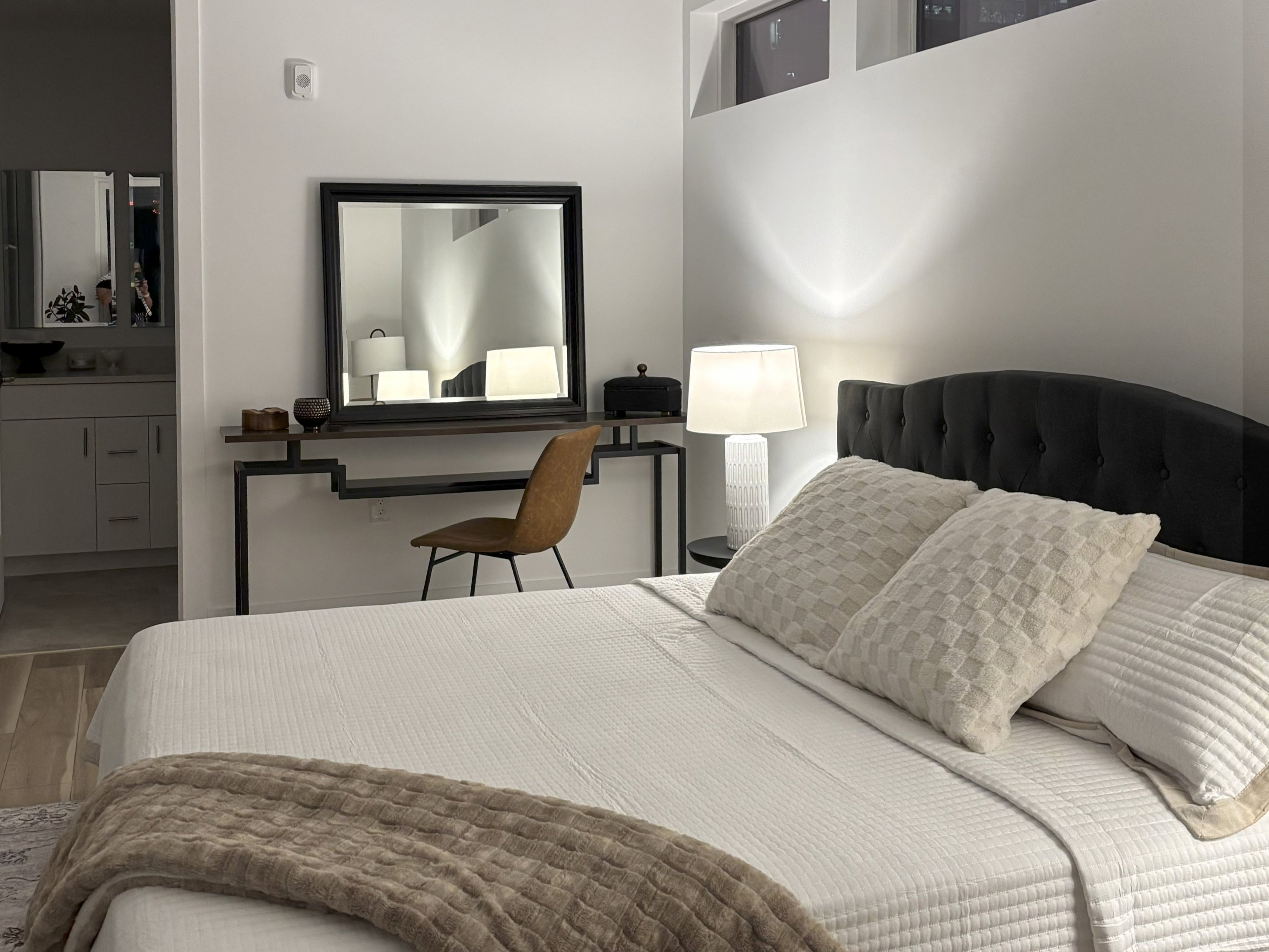 Bedroom Suite with wood finished floors and ensuite bathroom