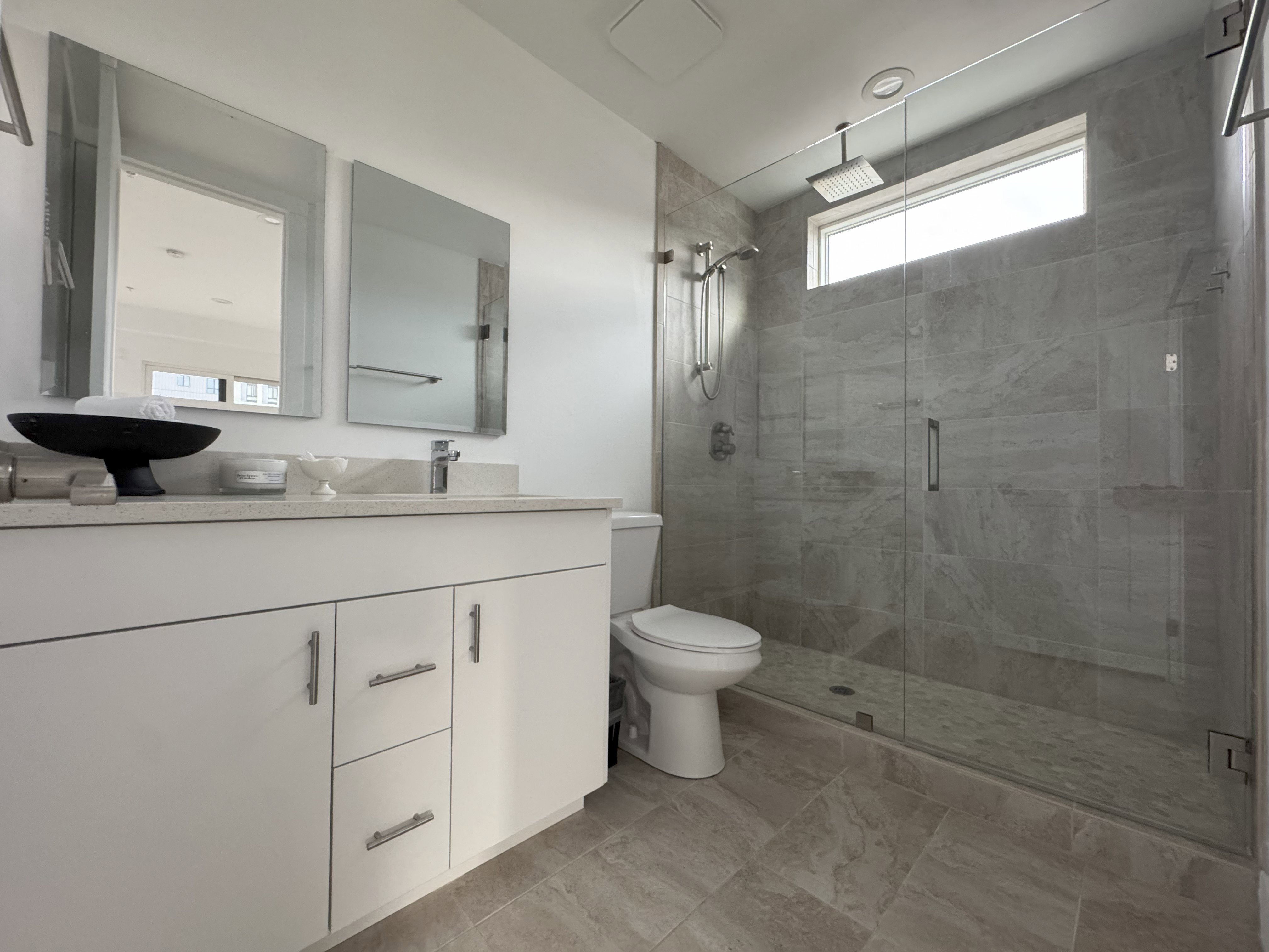 Full bathroom with vanity and a shower stall