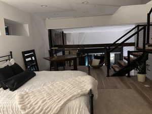 Twilight Bedroom 2 with wood finished floors and recessed lighting.