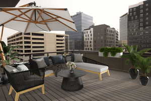 Wooden deck with outdoor lounge area and a city view