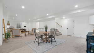 Dining area featuring recessed lighting and light carpet