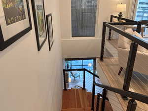 Stairs featuring wood finished floors