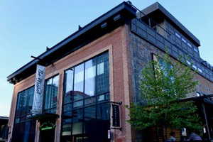 View of property exterior with stone siding