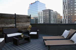 Deck featuring outdoor lounge area and a view of city!
