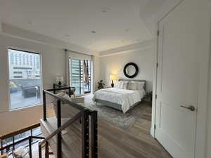 Primary Suite featuring light wood-style floors, recessed lighting and access to outside patio.