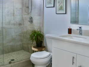 Full bathroom with vanity, a stall shower, and light tile patterned flooring