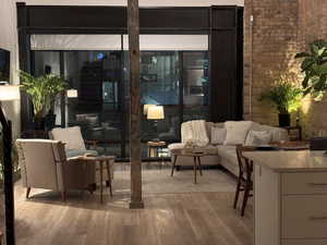 Twilight living room featuring brick wall