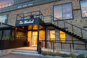 Exterior entry at dusk with brick siding