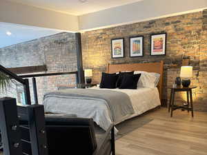 Bedroom 2 with wood finished floors and recessed lighting. Could be an office or flex room.