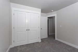 Unfurnished bedroom with carpet floors and a closet