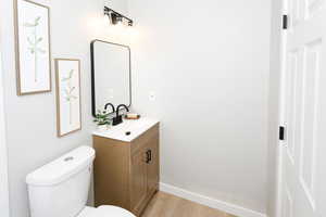 Bathroom featuring vanity and light wood finished floors