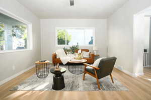 Sitting room with light wood finished floors and baseboards