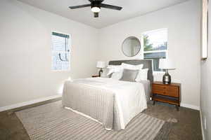 Bedroom with carpet, a ceiling fan, and multiple windows