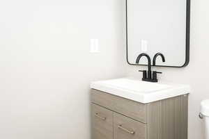 Half bath with vanity and toilet