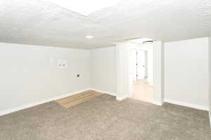 Bonus room with a textured ceiling and carpet