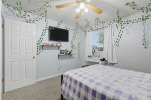 Bedroom with light colored carpet and a ceiling fan