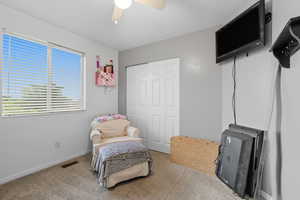 Sitting room with carpet flooring and ceiling fan